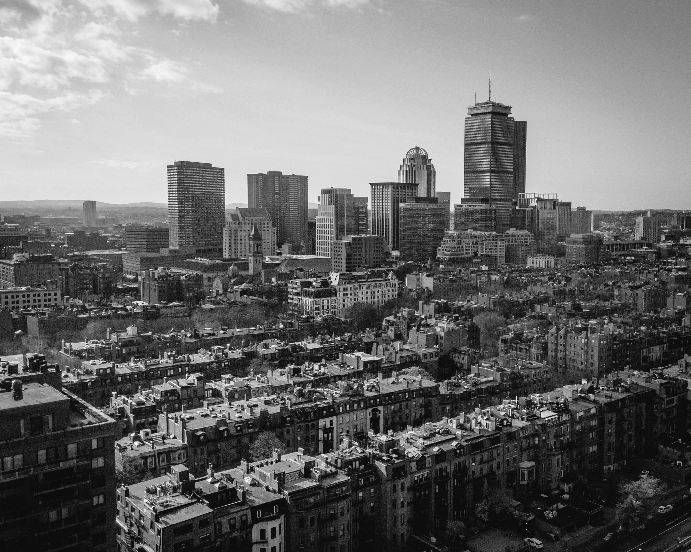 Aerial black-and-white view of the Boston, Massachusetts skyline and Back Bay rooftops